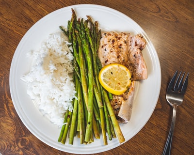 plate of asparagus beside fork